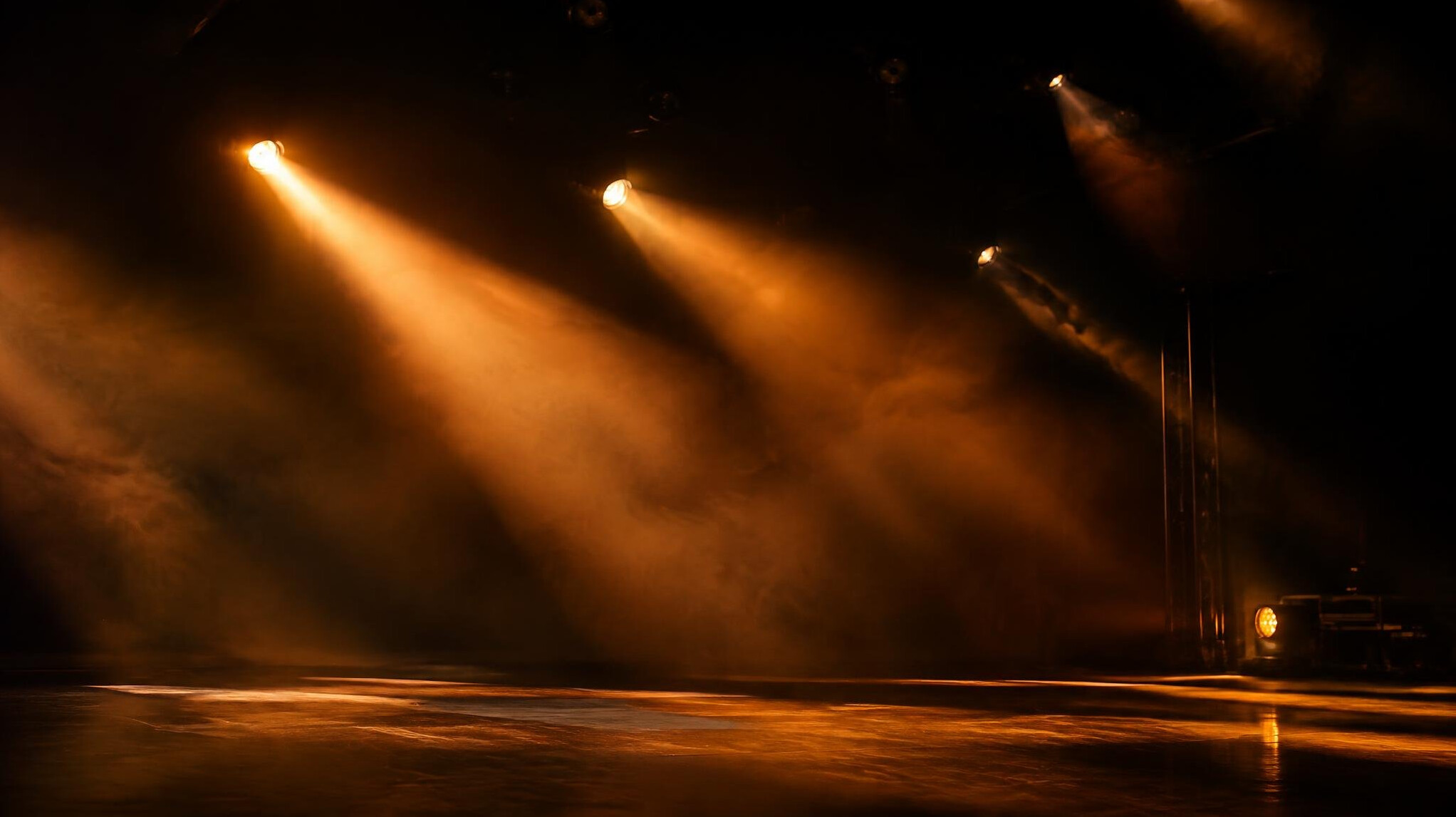 Stage lighting transition with spotlights sweeping across a dark stage